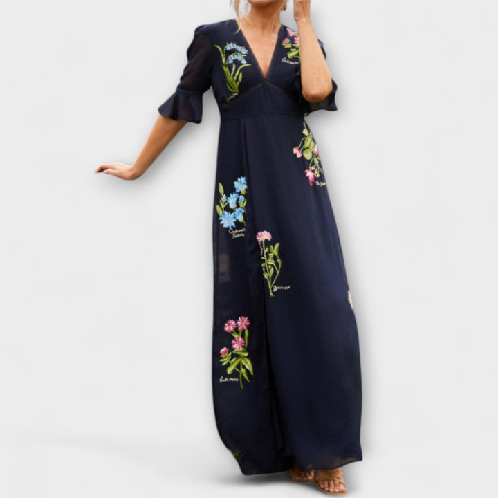 Elegant marineblå kjole med blomsterprint